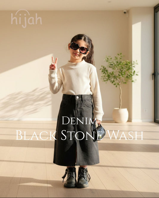 Child wearing Hijah Denim Black Stone Wash skirt with cream turtleneck and sunglasses