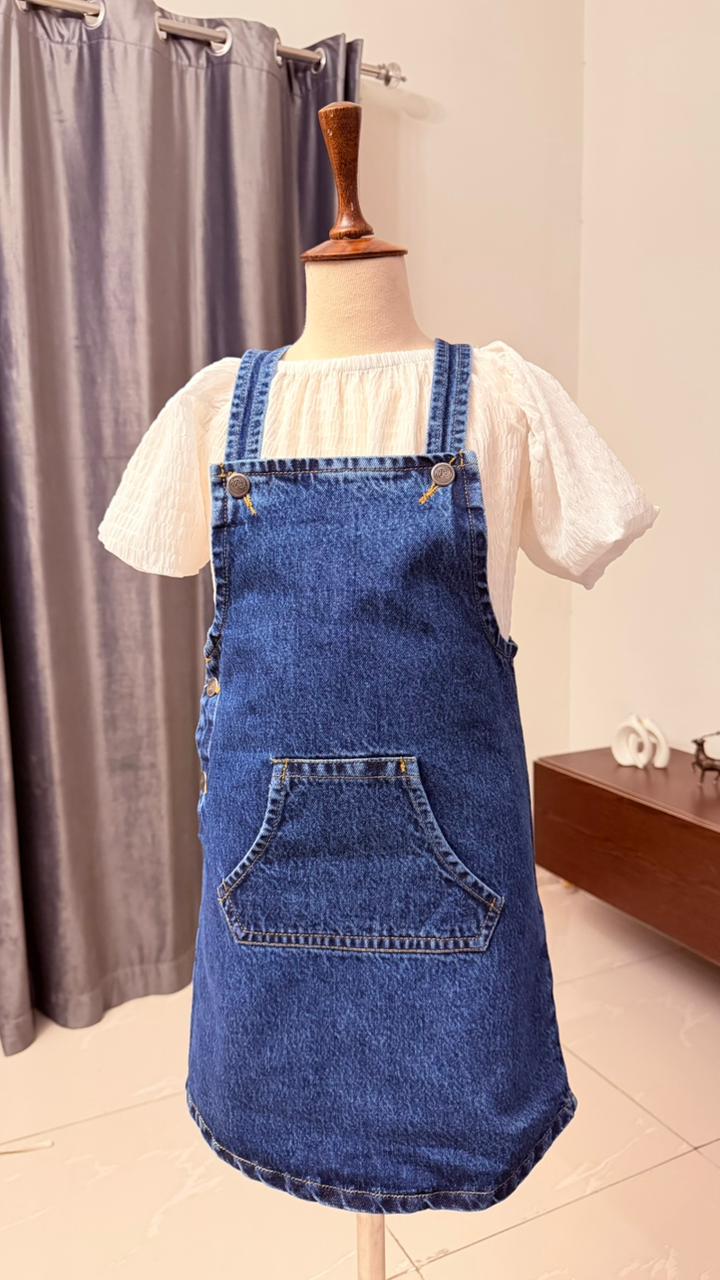 Blue denim pinafore dress for kids paired with white blouse - stylish and durable Eid outfit for children in Pakistan