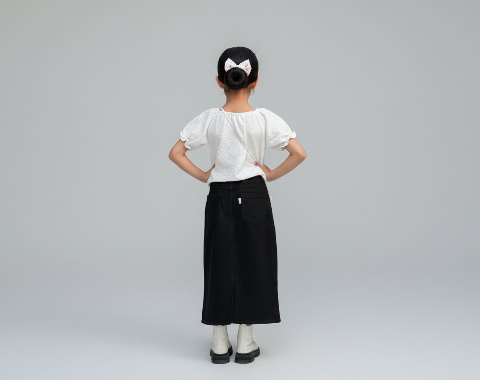 Child standing in front of a vintage car with decorative elements in the background